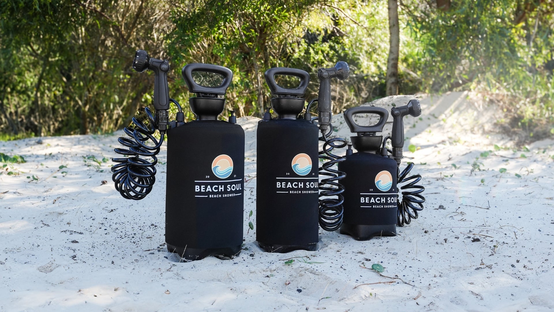 Three Beach Soul portable showers 2.6G Pro Food Grade, 2.1G and 1.3G set up outdoors for camping