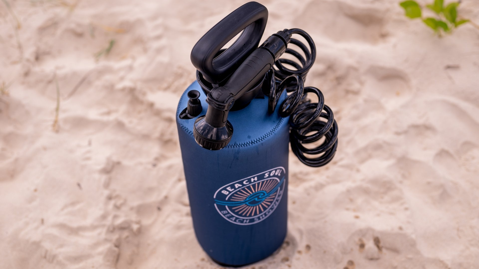 Beach Soul Portable Shower 2.1G Ocean Rise design standing on the sand