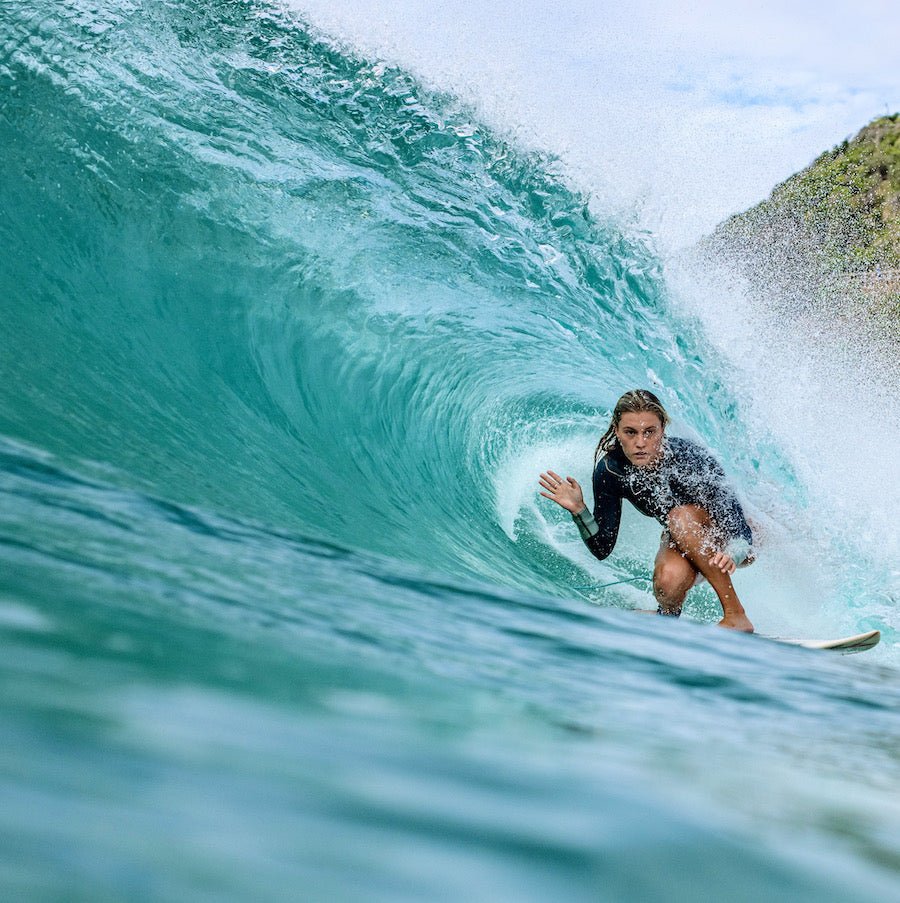 Sophie Fletcher surfing inside a turquoise wave
