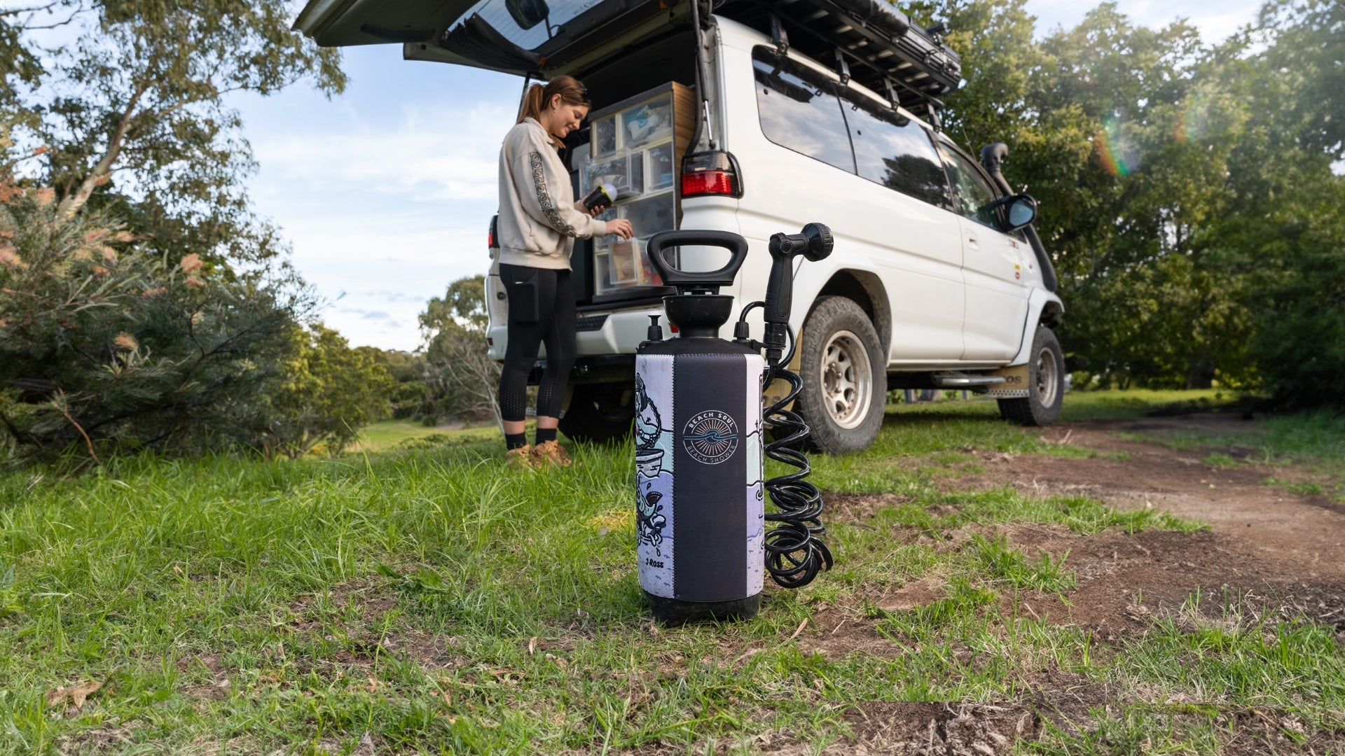 Beach Soul portable shower beside a vehicle during a road trip