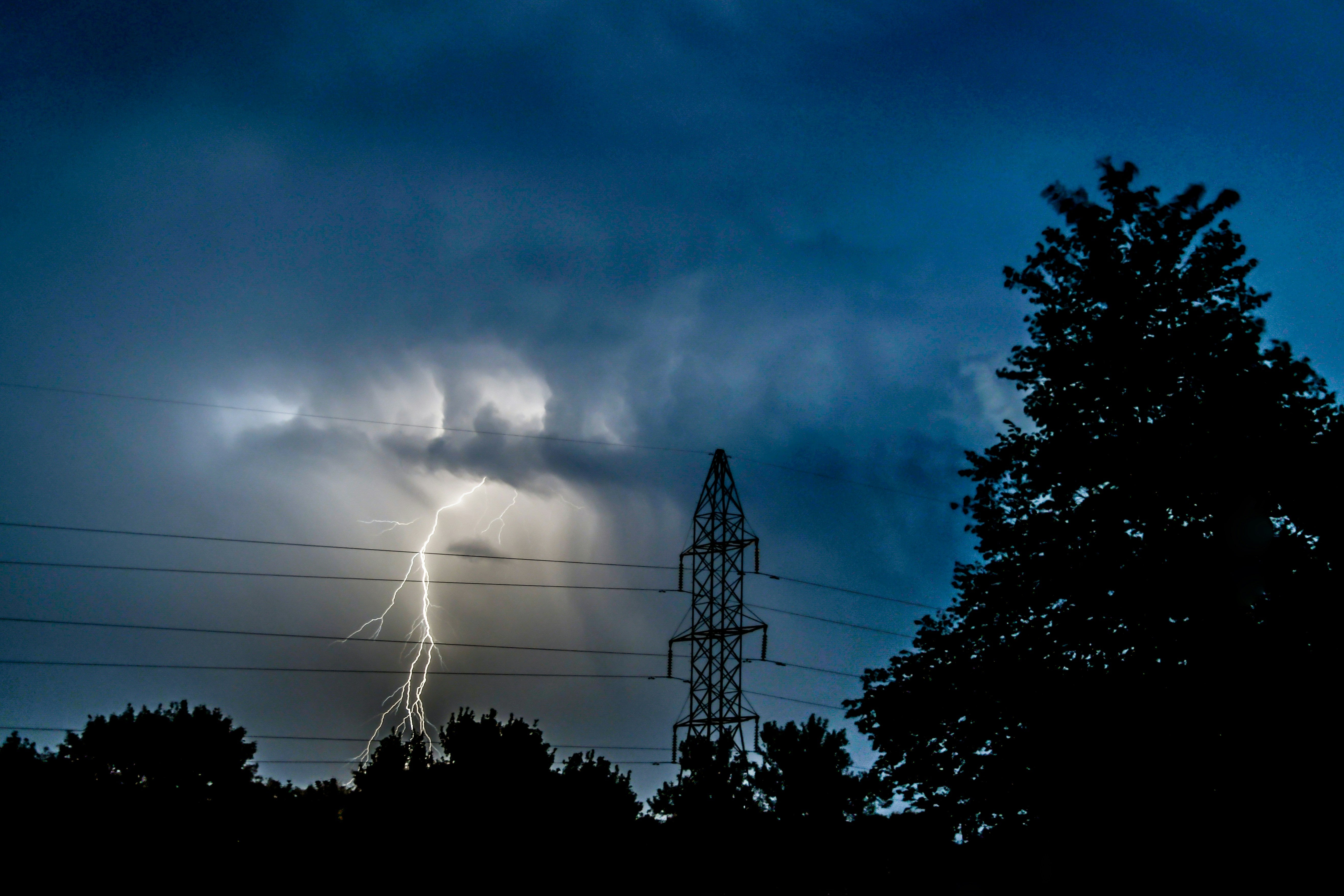 Lightning storm causing a power outage near electricity lines