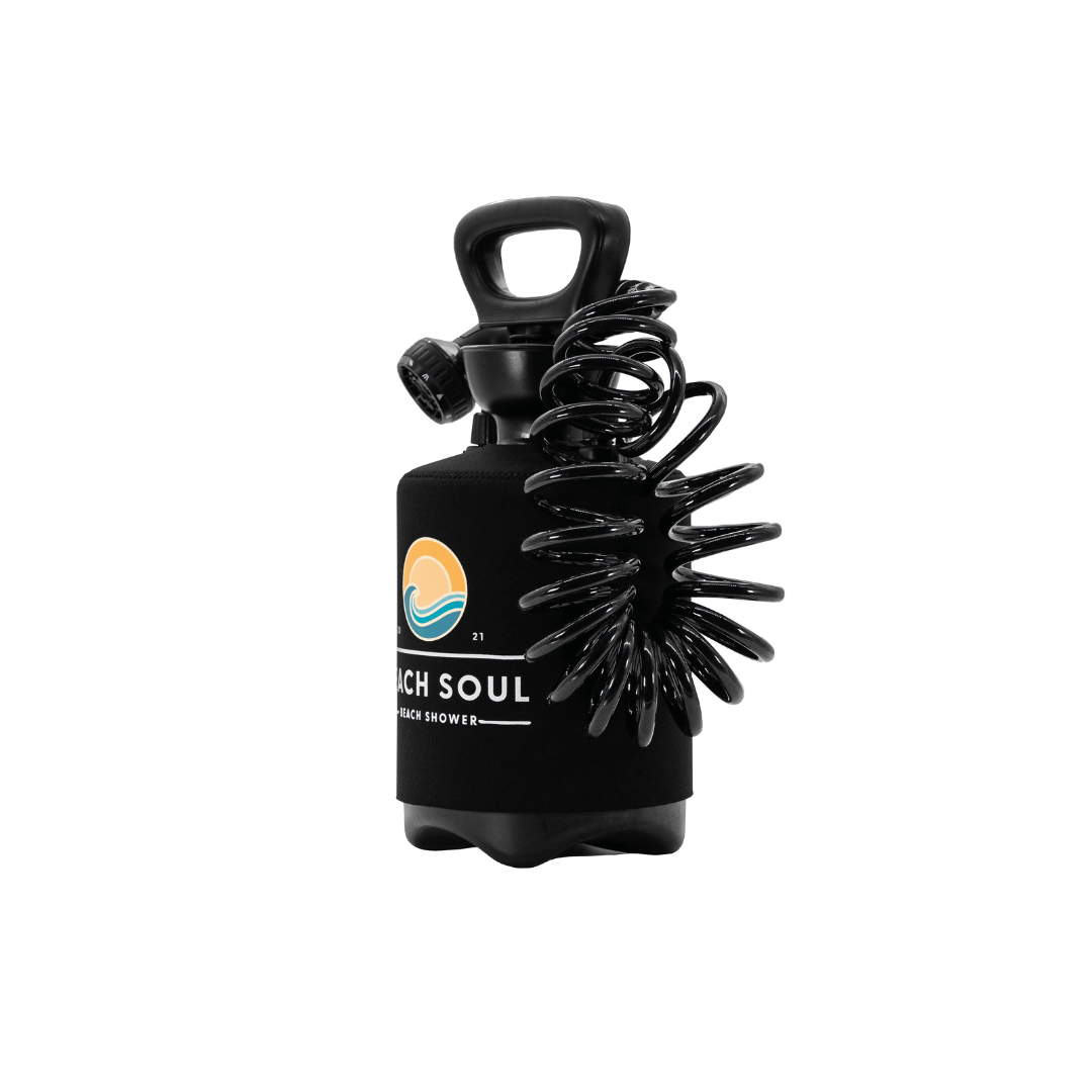 A black portable Beach Soul beach shower bottle featuring a coiled hose an ergonomic top handle and a colorful logo depicting an orange sun over a blue wave