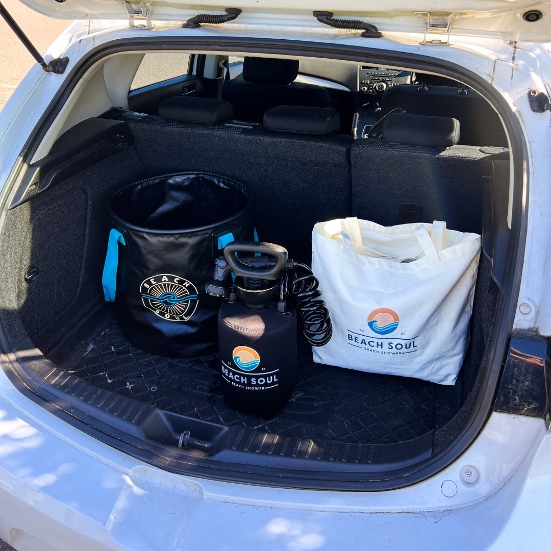 Beach Soul Beach Bag, Bag 'n' Mat and portable shower stored together in a car trunk