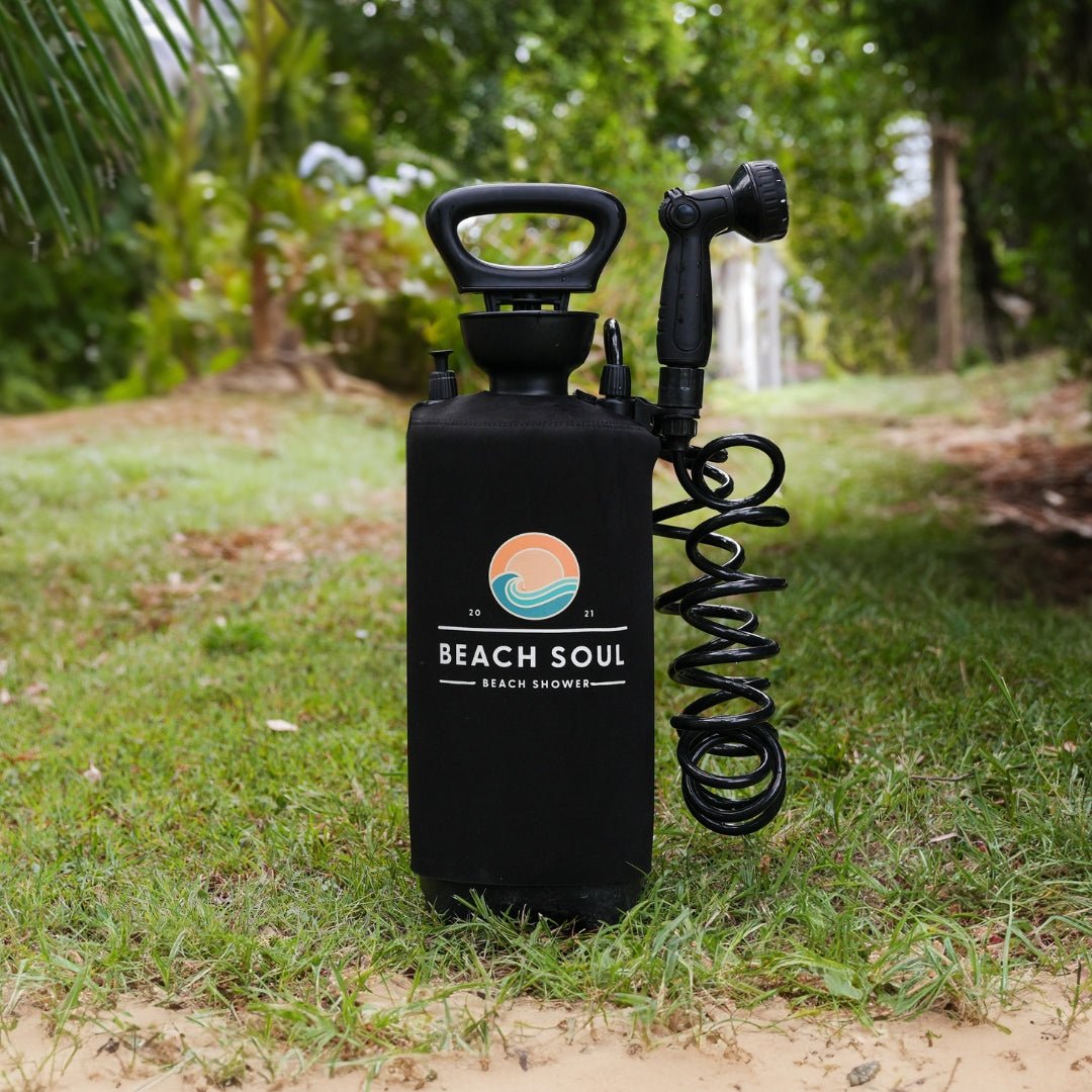 Beach Soul portable shower on grass with the shower head secured to the tank using the Tank Clip