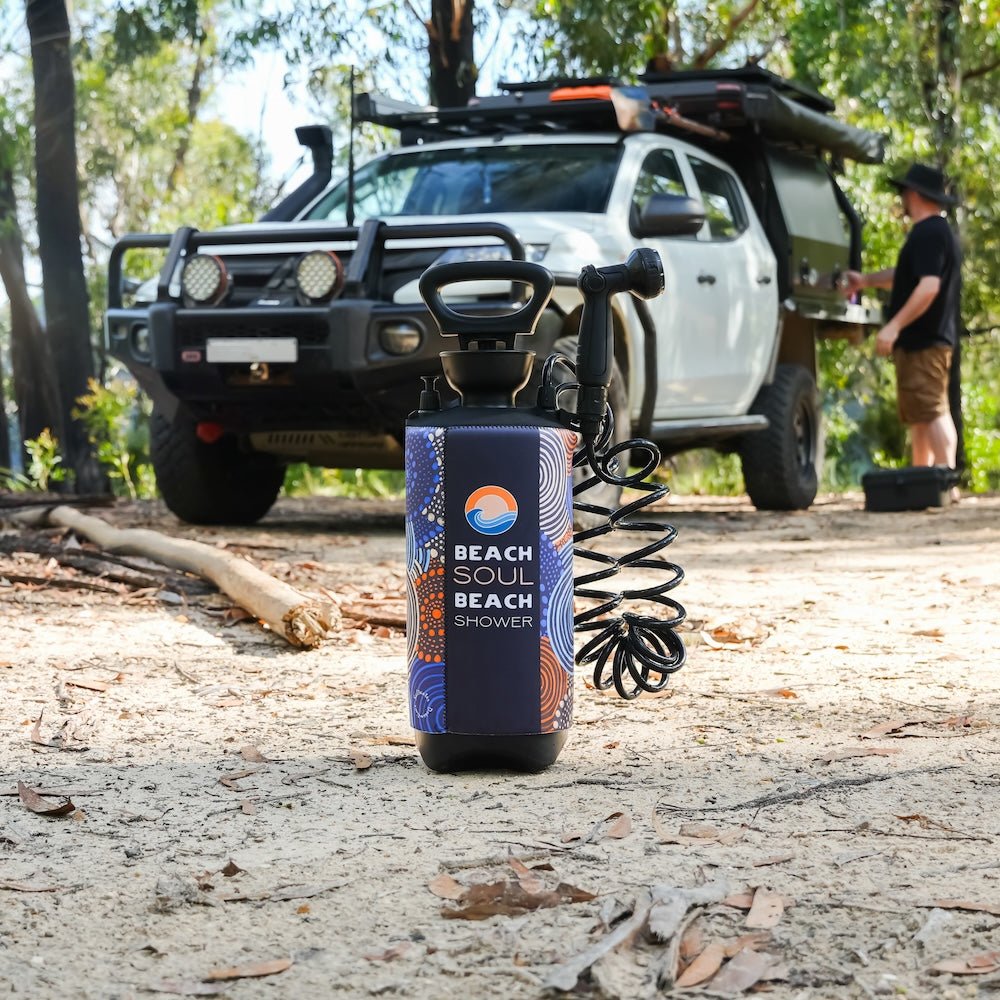 Beach Soul portable shower beside a four-wheel drive for outdoor vehicle rinsing