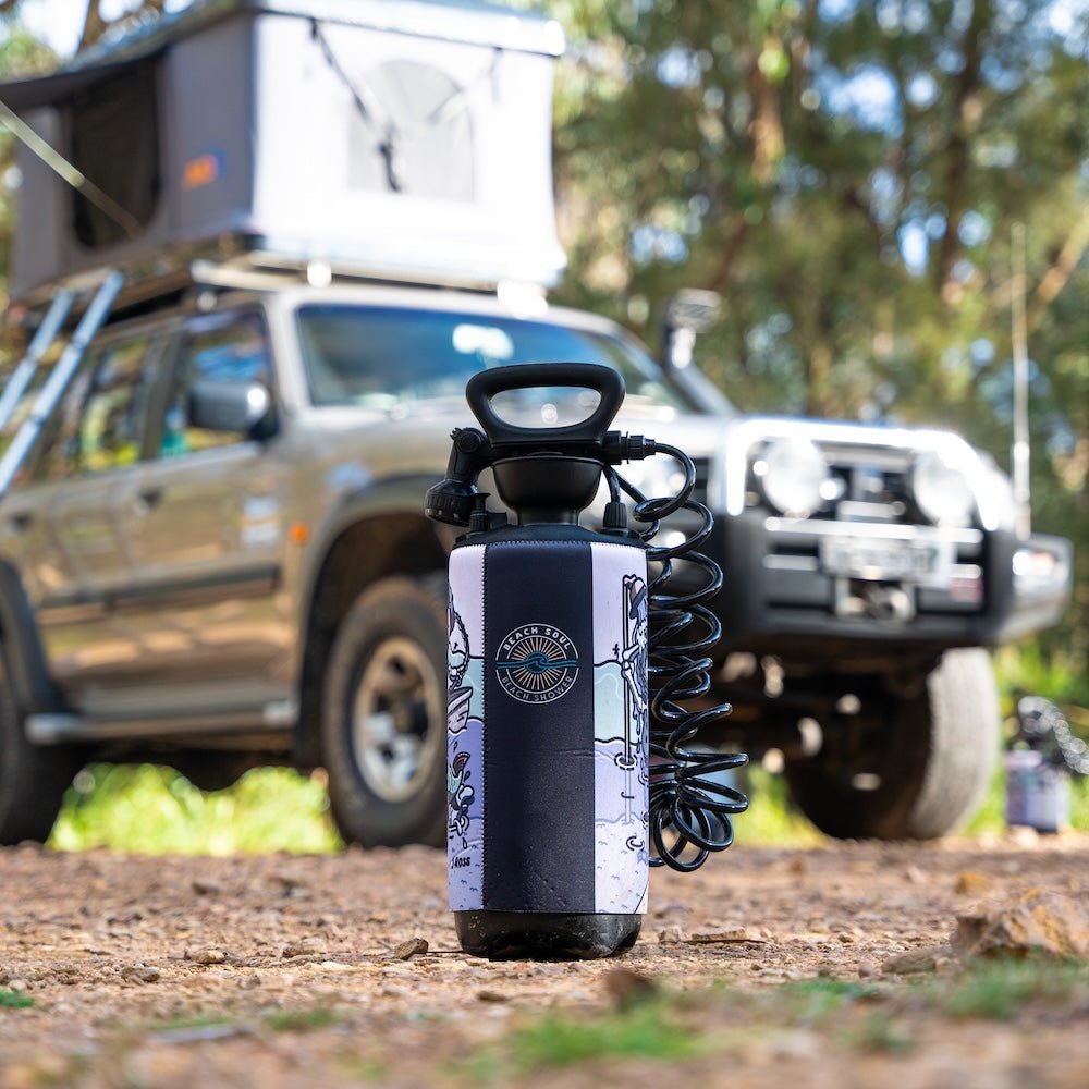 Beach Soul portable camp shower beside a four-wheel drive
