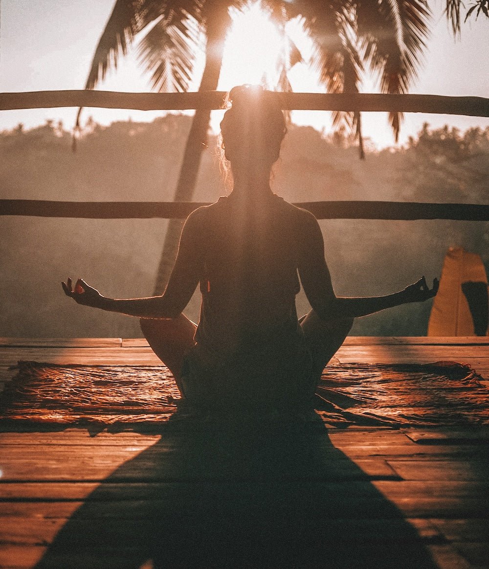 Person meditating away from screens during a digital detox