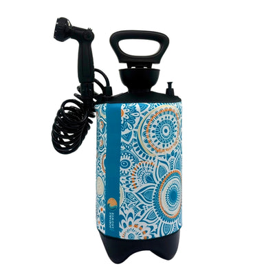 Portable pressurized outdoor shower on a white background featuring a cylindrical body with a blue, white, and orange mandala pattern, a black top handle, and a coiled black hose with a showerhead, plus a vertical blue stripe with "Portable Shower" text and a wave logo