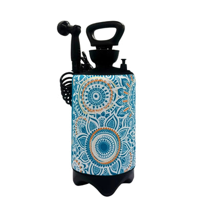 A product photo of a portable pressure sprayer bottle showcasing a vibrant teal blue, white, and orange mandala pattern, complete with a black pump handle, showerhead, coiled hose, and a sturdy black tripod base against a clean white background
