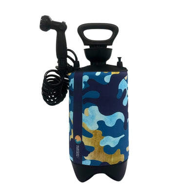 A portable pressurized shower pump featuring a blue, light blue, and tan camouflage pattern, a black top handle, coiled hose, and shower nozzle, displaying "Portable Shower" branding on its side