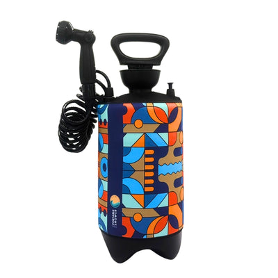 Geyser Systems portable shower with a vibrant geometric abstract pattern in orange blue teal and brown featuring a black coiled hose showerhead and top handle