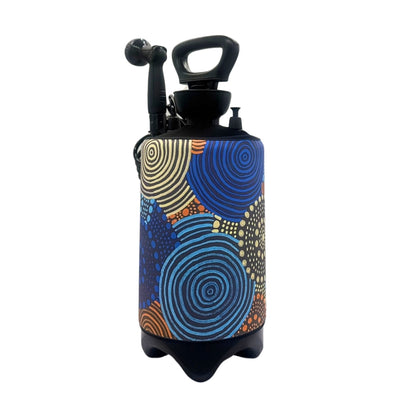 Black portable sprayer tank adorned with a vibrant Indigenous Australian art-style pattern featuring blue and yellow concentric circles, orange wavy lines, and black dot painting details