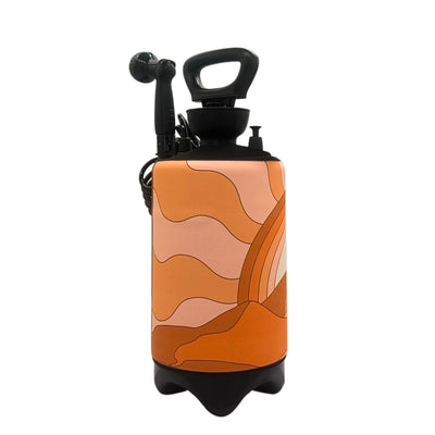 Product photo of a black portable sprayer with a removable orange-toned sleeve featuring an abstract retro design of wavy lines and layered arching stripes in shades of peach, orange, and brown