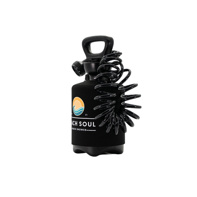 A black portable Beach Soul beach shower bottle featuring a coiled hose an ergonomic top handle and a colorful logo depicting an orange sun over a blue wave