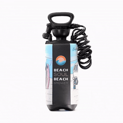A black portable Beach Soul beach shower with a pump handle, coiled hose, and a colorful sleeve depicting surfboards, a classic camper van, and an orange sun and blue wave logo
