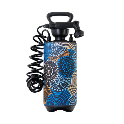 Portable pressure shower with a black handle and coiled hose featuring a vibrant abstract pattern of blue, orange, and beige dots and concentric circles