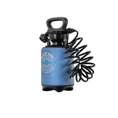 Product photography of a portable Beach Soul beach shower featuring a blue insulated sleeve with a white sun and wave logo, a black top handle, and a coiled black hose with nozzle on a white background
