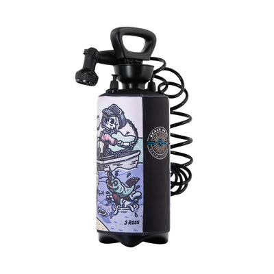 Graphic art by J Ross on a black portable pressure shower bottle featuring a skeleton DJing in a boat as a blue fish jumps from purple water, with a Beach Shower sun and wave logo and a black coiled hose and adjustable nozzle