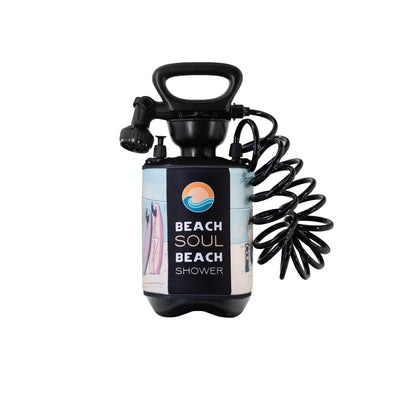 A black Beach Soul portable beach shower product image on a white background, featuring a top handle, coiled hose, and a colorful graphic wrap with pastel surfboards, a sun and wave logo, and beach scene illustrations